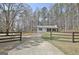 Long private driveway leads to a well-maintained home surrounded by mature trees and lush greenery at 1120 Minix Rd, Sharpsburg, GA 30277