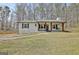 Charming home featuring a covered front porch with decorative hanging plants and classic black shutters at 1120 Minix Rd, Sharpsburg, GA 30277