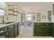 Stylish kitchen with dark cabinetry, modern appliances, and a view into the dining area at 1120 Minix Rd, Sharpsburg, GA 30277