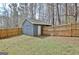 This backyard shows a detached shed with a wooden fence for added privacy at 1120 Minix Rd, Sharpsburg, GA 30277