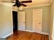 Charming bedroom features a ceiling fan and beautiful hardwood floors at 121 Flat Rock Rd, Villa Rica, GA 30180