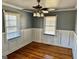 Bedroom with wood paneling and natural light from two windows at 121 Flat Rock Rd, Villa Rica, GA 30180