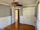 Bedroom with wood paneling, hardwood floors and a ceiling fan at 121 Flat Rock Rd, Villa Rica, GA 30180