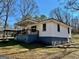 Side view of home with a covered porch featuring wood railings and ample yard space at 121 Flat Rock Rd, Villa Rica, GA 30180