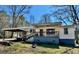 Charming single-story home featuring a front porch and carport on a sunny day at 121 Flat Rock Rd, Villa Rica, GA 30180