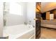 Bright bathroom with a soaking tub, offering a luxurious space for relaxation, with an open view to the bedroom at 1127 Lehavre Ct, Hampton, GA 30228