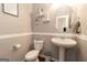Well-appointed half bathroom with pedestal sink and decorative shelving at 1127 Lehavre Ct, Hampton, GA 30228