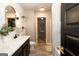Elegant bathroom features double sinks, granite counters, modern fixtures and stylish mirrors for a spa-like experience at 1127 Lehavre Ct, Hampton, GA 30228