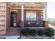 Inviting front porch with decorative details and comfortable seating, enhancing curb appeal at 1127 Lehavre Ct, Hampton, GA 30228