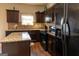 Well-equipped kitchen with granite countertops, dark cabinets, and modern appliances at 1127 Lehavre Ct, Hampton, GA 30228