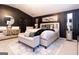 Stunning main bedroom with sleek dark walls, plush bed, designer rug, and ample natural light from large windows at 1127 Lehavre Ct, Hampton, GA 30228
