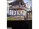 Spacious backyard with a two-story deck, a covered patio, and seating at 332 Black Willow Ct, Locust Grove, GA 30248