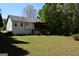 Large backyard with mature trees and a view of the house at 332 Black Willow Ct, Locust Grove, GA 30248