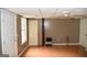 Finished basement with ample space, featuring hardwood floors, multiple doors, and windows at 332 Black Willow Ct, Locust Grove, GA 30248
