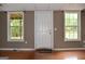 Spacious basement featuring two windows letting in natural light and a convenient access door at 332 Black Willow Ct, Locust Grove, GA 30248