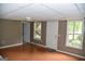 Spacious basement area with windows, doors, ceiling fan, and hardwood floors at 332 Black Willow Ct, Locust Grove, GA 30248