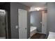 Modern bathroom featuring luxury vinyl floors, gray walls and a soaking tub at 332 Black Willow Ct, Locust Grove, GA 30248
