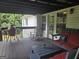 Relaxing back deck with grill, sofa and rocking chair at 332 Black Willow Ct, Locust Grove, GA 30248