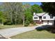 Long driveway leads to a well maintained home with mature trees at 332 Black Willow Ct, Locust Grove, GA 30248