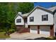 Two story home with two car garage and brick entryway at 332 Black Willow Ct, Locust Grove, GA 30248