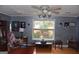 Stylish living room with natural light, decorative wall art, and unique furnishings at 332 Black Willow Ct, Locust Grove, GA 30248