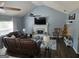 Cozy living room with fireplace, ceiling fan, vaulted ceiling, and wood floors at 332 Black Willow Ct, Locust Grove, GA 30248