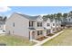 Modern townhome exteriors with gray and white siding, brick accents, and well-maintained landscaping at 456 Reflection Dr # 20, Stockbridge, GA 30281