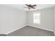 Neutral bedroom with a ceiling fan, a window bringing in natural light, and carpeted floors at 75 Heatherstone Way, Covington, GA 30016