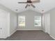 Carpeted bedroom with vaulted ceiling, a ceiling fan, and two windows at 75 Heatherstone Way, Covington, GA 30016