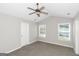 Bedroom featuring vaulted ceiling, ceiling fan, carpet floors, and two windows at 75 Heatherstone Way, Covington, GA 30016