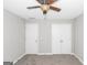 Neutral bedroom with a ceiling fan, carpeted floors, a closet, and another door at 75 Heatherstone Way, Covington, GA 30016