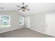 Bedroom with a ceiling fan, two windows, and carpet flooring at 75 Heatherstone Way, Covington, GA 30016