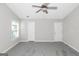 Empty bedroom with a ceiling fan, carpeted floors, and two closets at 75 Heatherstone Way, Covington, GA 30016