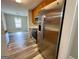 Bright kitchen with stainless steel refrigerator and appliances, and laminate flooring at 75 Heatherstone Way, Covington, GA 30016