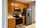 Efficient kitchen with stainless steel appliances, light countertops, and wood cabinets provides functionality at 75 Heatherstone Way, Covington, GA 30016