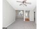 Bright living room with carpet, neutral walls, ceiling fan, and large windows offering ample natural light at 75 Heatherstone Way, Covington, GA 30016