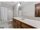 Bathroom featuring a shower-tub combo, wood vanity, and neutral wall color at 2940 E Lake Rd, Mcdonough, GA 30252