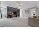 Light-filled bonus room featuring carpet floors, neutral walls, and a ceiling fan with overhead lighting at 2940 E Lake Road, Mcdonough, GA 30252