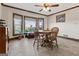 Sunlit dining room with a ceiling fan and a classic wood dining set at 2940 E Lake Road, Mcdonough, GA 30252