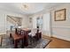 Light-filled dining room featuring a modern table, wood benches, and an elegant light fixture at 2940 E Lake Road, Mcdonough, GA 30252