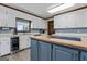 Bright kitchen with white cabinets, stainless steel appliances, and a wooden countertop island at 2940 E Lake Road, Mcdonough, GA 30252