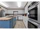 Bright kitchen with white cabinets, stainless steel appliances, and a wooden countertop island at 2940 E Lake Road, Mcdonough, GA 30252