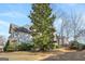 Rear exterior of the home showcasing ample yard space, a wooden deck, and attractive landscaping at 3860 Bays Ferry Trl, Marietta, GA 30062