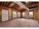 Spacious unfinished basement area, featuring wood framing, carpeting, and natural light from windows at 3860 Bays Ferry Trl, Marietta, GA 30062