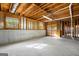 Unfinished basement featuring concrete foundation, wood framing, and natural light from windows at 3860 Bays Ferry Trl, Marietta, GA 30062