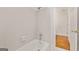 Well-lit bathroom showcasing a tiled bathtub and an open doorway at 3860 Bays Ferry Trl, Marietta, GA 30062