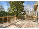 A wooden deck provides an inviting outdoor space surrounded by lush greenery and a beautiful backyard view at 3860 Bays Ferry Trl, Marietta, GA 30062