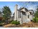 Back of the house with light stucco, a chimney, and a wooden deck with stairs to the backyard at 3860 Bays Ferry Trl, Marietta, GA 30062