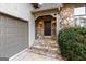 Close-up of the front door with stone accents, steps, and a well-maintained garden at 3860 Bays Ferry Trl, Marietta, GA 30062