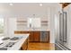 Charming kitchen features wood cabinets, stainless steel appliances, and a breakfast bar area with cooktop at 3860 Bays Ferry Trl, Marietta, GA 30062